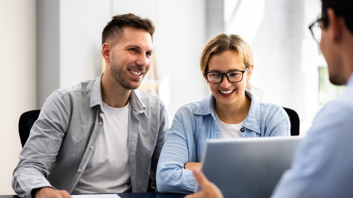 Couple discussing their financial goals with an adviser